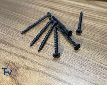 A cluster of black oxide chipboard screws from THV Fasteners, showcasing their coarse threads and countersunk heads, ideal for dark wood and furniture assembly.