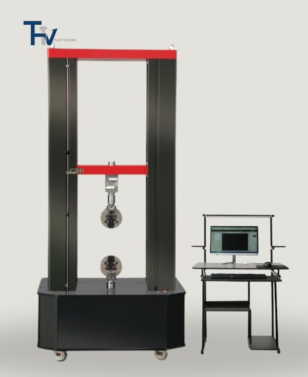 A large universal testing machine (UTM) from THV Fasteners' lab, equipped with a computer interface, used for tensile and compression strength testing of fasteners.